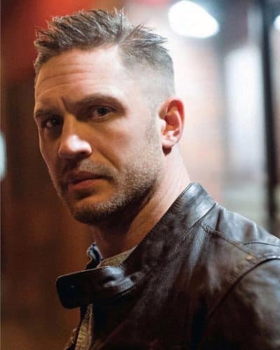 Tom Hardy's spiky, bald fade haircut with shaved beard.