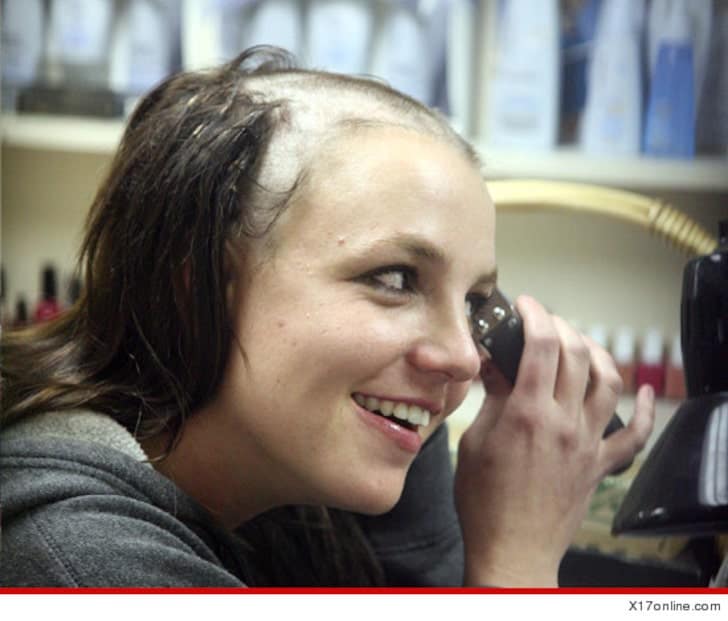 Britney Spears shaving with balding clippers.