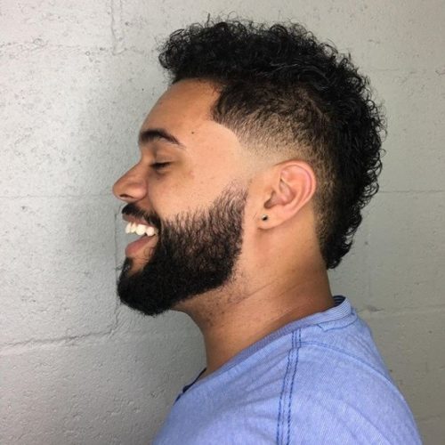 Curly Faux Hawk style with a low taper.