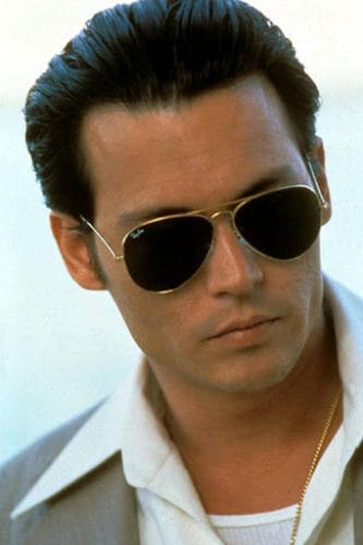 Johnny Depp as Donnie Brasco. Sporting slicked back hair with Ray-Ban sunglasses.