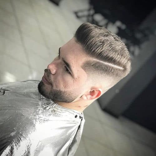 Cool and trendy beard fade with parted hairstyle.