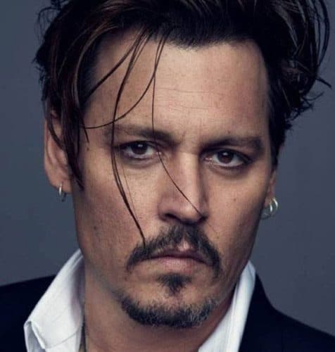 Johnny Depp with a short style and very long hair on top paired with a goatee.