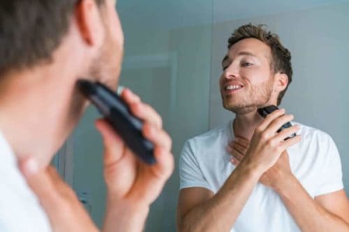 Facial hair removal with electric razor.