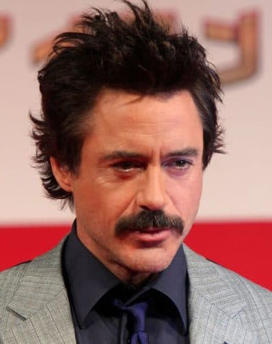 Robert Downey Jr grows a mustache with wild hairstyle.