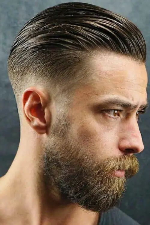 slicked back haircut with low fade beard design