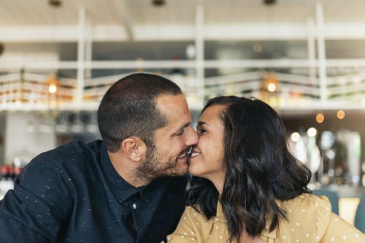 Couple kissing slowly to avoid beard burn.