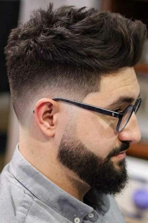 tousled low fade haircut with beard