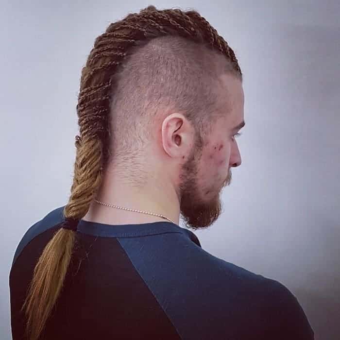 Single Viking braid, shaved head and ponytail.