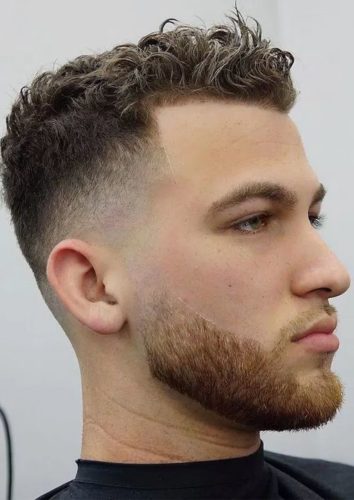 Wavy Ivy League Haircut featuring a taper fade that's blended into a beard fade.