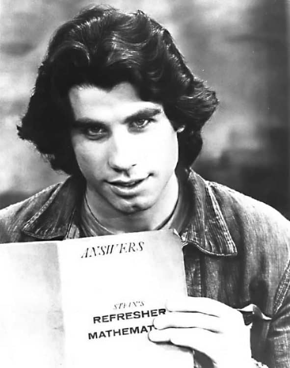 Younger John Travolta with long hair